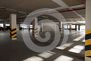 Open parking garage with cars on sunny day