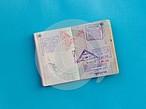 Open passport with several stamps from Thailand and Malaysia inside