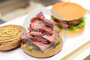 Open pastrami sandwich on a toasted bun