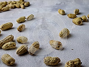 Open peanuts shot macro in studio, white wall texture background