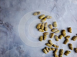 Open peanuts shot macro in studio, white wall texture background