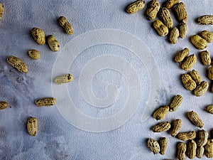 Open peanuts shot macro in studio, white wall texture background