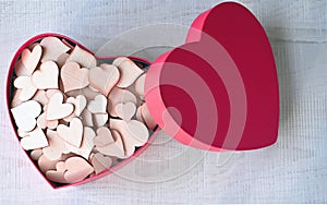 Open pink heart shaped gift box with hearts on grey background. Design for Valentine's Day