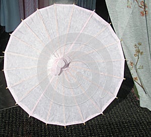 Open pink paper umbrella