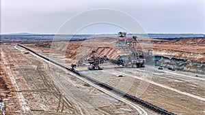 Open pit coal mine with huge backhoe digger drone