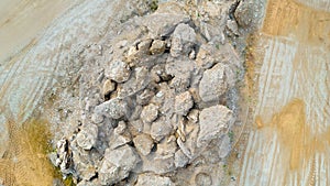 Open pit gravel mining sight with gravel field, big stones photographed from above with a drone.