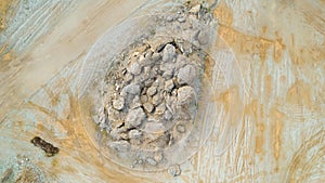 Open pit gravel mining sight with gravel field, big stones photographed from above with a drone.