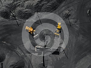 Open pit mine, coal loading in trucks, transportation and logistics, top view aerial. Concept industrial