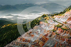 Open pit mine in misty mountains