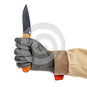 Open pocket folding knife with bright orange handle clenched in a worker fist in black protective glove isolated on white