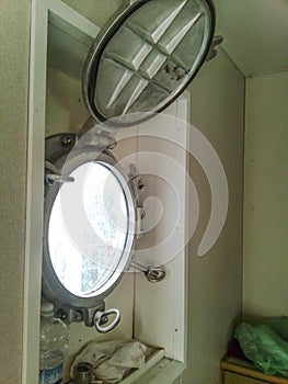 An open porthole in the ship`s cabin