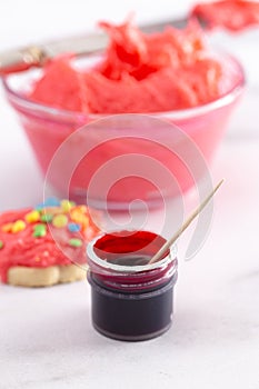 Open Pot of Gel Food Coloring with Dyed Icing and Iced Cookie