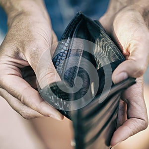 Open purse with one coin inside as a sign of lack of mo