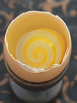 Open raw egg in an eggcup