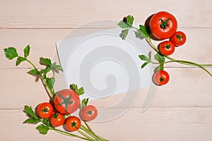 Open recipe book with fresh vegetables on wooden table.