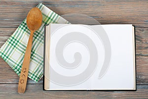 Open recipe book on wooden background.