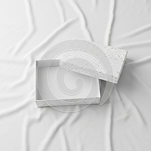 Open rectangular gift box with a lid, placed on a textured white