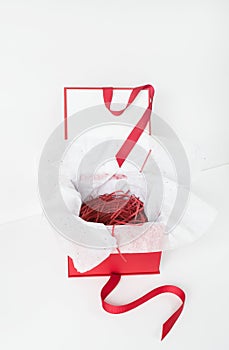 Open Red Box with White Tissue Paper Filled with Red Paper Strips