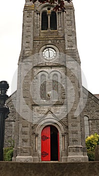 Open red Door to the Church, Catholic Church in Ireland. Red antique door