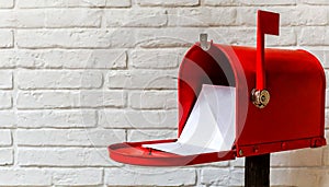 Open Red Letter Box with White Envelopes Against a White Brick Wall - Generative Ai