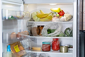 Open Refrigerator Filled With Fresh Fruits And Vegetables