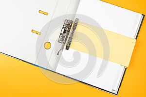 Open ring binder, file folder on orange background