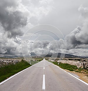 Open road and stormy clouds