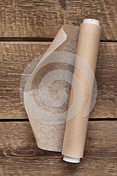 An open roll of paper on the wooden table background