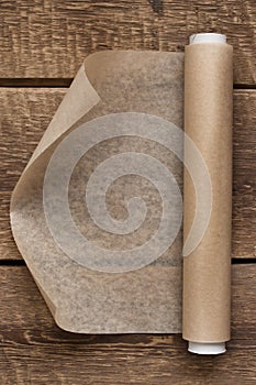 An open roll of paper on the wooden table background