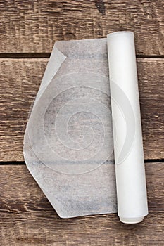 An open roll of paper on the wooden table background