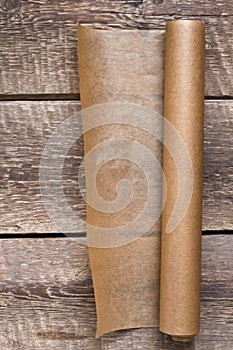 An open roll of paper on the wooden table background