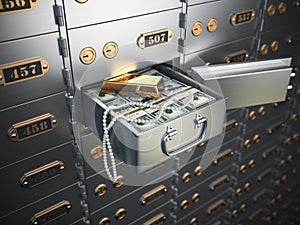 Open safe deposit box with money, jewels and golden ingot.