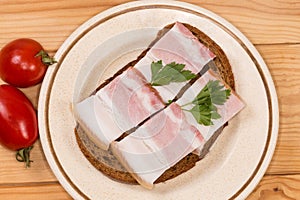 Open sandwich with boiled-smoked pork belly and cherry tomatoes