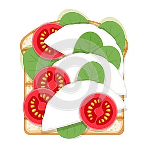 Open sandwich with spinach, soft cheese and tomato slices.