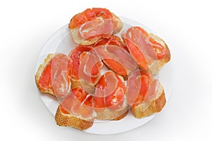 Open sandwiches with salted salmon, baguette and butter on dish