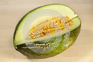 Open Santa Claus melon on wooden table