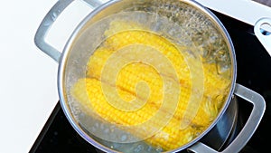 Open the saucepan with corn in boiling water