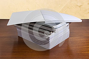 Open school exercise book lies on other exercise books stack