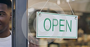 Open sign, black business man and cafe with welcome and service poster for restaurant. Coffee shop, window info and