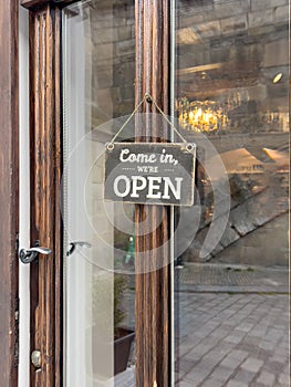 open sign on entrance door of a shop or store