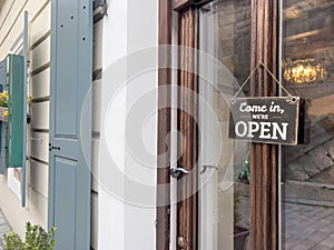 open sign on entrance door of a shop or store