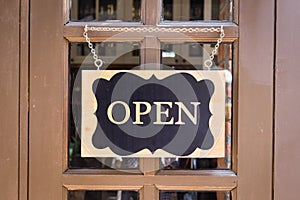 Open sign hanging on deluxe door