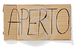 Open sign in italian language against a cardboard - aperto means open photo