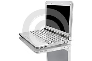 Open silver netbook with reflected shadow