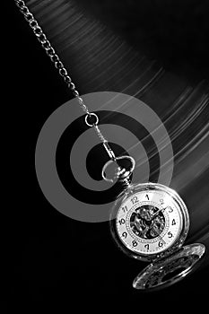 Pocket watch swinging on chain with motion blur trail