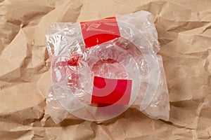 Open small bag of air bubble wrap with red sticky tape