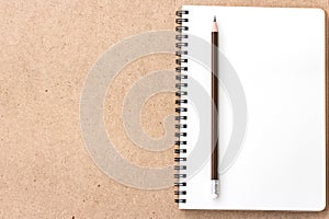 Open Small notepad with pencil and on wood