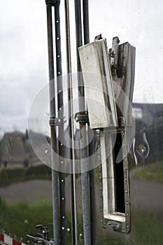 Open small window on the old semi trailer with stainless steel w