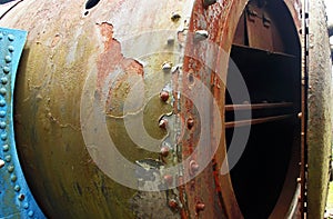 OPEN SMOKE STACK DOOR ON THE FRONT OF AN OLD RUSTED STEAM LOCOMOTIVE