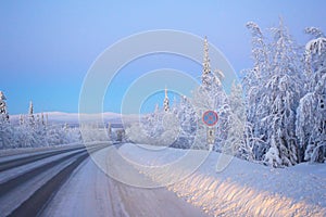 Open snow-covered road.Winter sunset.